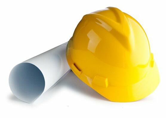 home & commercial remodeling with a Yellow Hard Hat sitting on top of roll up paper